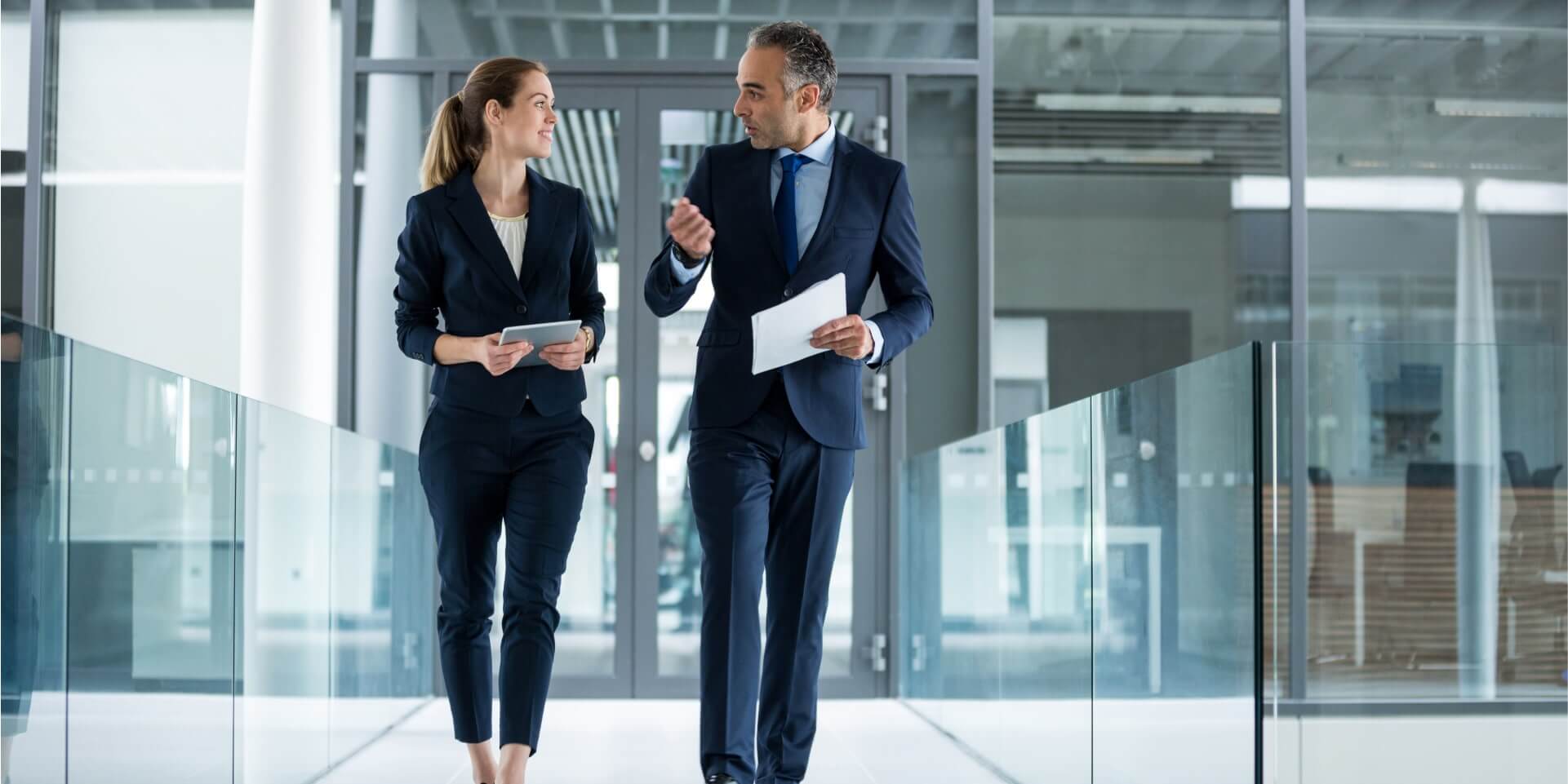Two colleagues collaborating on a custom technology project in a modern workplace