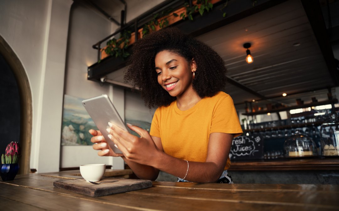 Woman reading tablet while in a café