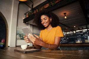 Woman reading tablet while in a café